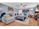 Spacious living room showcasing hardwood floors, a ceiling fan, and a comfortable sectional sofa at 2420 Kannapolis Hwy, Concord, NC 28027