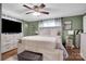 The main bedroom features a ceiling fan, white dresser, and a well lit space at 2420 Kannapolis Hwy, Concord, NC 28027