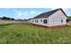 New home exterior features a backyard with green grass and a black roof against a blue sky at 2508 Rock Dam Rd, Lincolnton, NC 28092