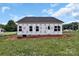New home exterior features a backyard with green grass and a black roof against a blue sky at 2508 Rock Dam Rd, Lincolnton, NC 28092
