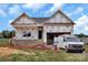 A new construction home featuring brick foundation and two-car garage with a work van at 2508 Rock Dam Rd, Lincolnton, NC 28092