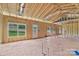 A spacious framed living room features stud walls, wiring, duct work, windows, and an exterior door at 2508 Rock Dam Rd, Lincolnton, NC 28092