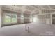 Open-concept living room with unfinished walls, new windows, and natural light for creative design at 2508 Rock Dam Rd, Lincolnton, NC 28092