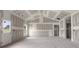 Bright, unfinished living room featuring an exterior door, ample windows, and a spacious layout at 2508 Rock Dam Rd, Lincolnton, NC 28092