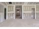 Spacious living room with unfinished walls, bare floors, and natural light streaming through the door at 2508 Rock Dam Rd, Lincolnton, NC 28092