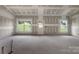 A new construction living room features bare drywall, two windows, and an exterior door at 2508 Rock Dam Rd, Lincolnton, NC 28092