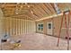 A view of the framed living room with a high ceiling, exposed wooden beams, and natural light from the windows at 2508 Rock Dam Rd, Lincolnton, NC 28092