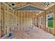 A framed living room area boasts natural light from two windows and an orange ladder at 2508 Rock Dam Rd, Lincolnton, NC 28092