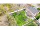 Aerial view of the landscaped backyard with a white fence, trees, and green lawn, creating a private outdoor space at 2510 Bricker Dr, Charlotte, NC 28273