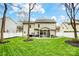 Beautiful backyard featuring a well-maintained lawn, white fence, and screened-in porch perfect for outdoor relaxation at 2510 Bricker Dr, Charlotte, NC 28273