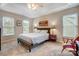 Inviting bedroom with neutral tones, cozy carpet, bedside lamps and large windows offering lots of natural light at 2510 Bricker Dr, Charlotte, NC 28273