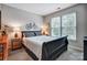 Comfortable bedroom featuring a sleek bedframe, modern wall art, bedside lamps and windows offering natural light at 2510 Bricker Dr, Charlotte, NC 28273