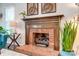 Close-up of a classic brick fireplace with wood mantel and decorative accents at 2510 Bricker Dr, Charlotte, NC 28273