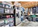 Spacious garage equipped with shelving, storage bins, and a stainless steel refrigerator at 2510 Bricker Dr, Charlotte, NC 28273