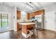 Well-lit kitchen with stainless steel appliances, central island with seating and modern lighting fixture at 2510 Bricker Dr, Charlotte, NC 28273