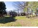 Spacious backyard featuring a well-maintained lawn, mature trees, and back home exterior at 2650 31St Street Ne Ct, Hickory, NC 28601