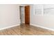 Bedroom featuring wood-look floors, two bright windows, and a half bathroom attached at 2650 31St Street Ne Ct, Hickory, NC 28601