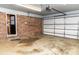 Spacious garage featuring a brick accent wall, garage door, and an exterior entry door at 2650 31St Street Ne Ct, Hickory, NC 28601