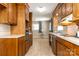 Galley kitchen with hardwood cabinets, updated appliances, and tile floor at 2650 31St Street Ne Ct, Hickory, NC 28601