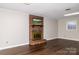 Spacious living room featuring a brick fireplace and laminate wood floors at 2650 31St Street Ne Ct, Hickory, NC 28601