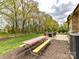 Outdoor patio seating area with a colorful picnic table, grill, and wooded views at 3012 Ocean Dr, Monroe, NC 28110