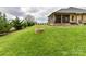 Spacious backyard with a charming stone fire pit feature at 3012 Ocean Dr, Monroe, NC 28110