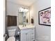Powder room features a white vanity, framed artwork, and updated fixtures at 3012 Ocean Dr, Monroe, NC 28110