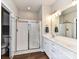 Bright bathroom featuring a glass-enclosed shower, double vanity with modern fixtures, and ample counter space at 3012 Ocean Dr, Monroe, NC 28110