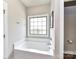 Serene bathroom with a soaking tub, offering a private retreat for relaxation and rejuvenation, complete with soft natural light at 3012 Ocean Dr, Monroe, NC 28110