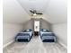 Cozy bedroom in the attic with two beds, slanted ceilings, ceiling fan, and neutral carpet at 3012 Ocean Dr, Monroe, NC 28110