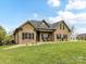 Sprawling front yard leads to a classic brick home, complete with covered entry and decorative flower pots at 3012 Ocean Dr, Monroe, NC 28110