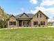 Charming brick home with a manicured lawn, covered porch, and classic black shutters at 3012 Ocean Dr, Monroe, NC 28110