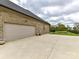Spacious garage and concrete driveway with a well-maintained landscape at 3012 Ocean Dr, Monroe, NC 28110