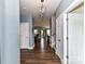 Bright hallway with hardwood floors leads into a seamlessly connected living and dining space at 3012 Ocean Dr, Monroe, NC 28110