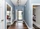 Light blue hallway with hardwood floors showcases entrances to office, bedroom, and front door at 3012 Ocean Dr, Monroe, NC 28110