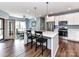 Modern kitchen with a center island, white cabinets, stainless steel appliances, and pendant lighting at 3012 Ocean Dr, Monroe, NC 28110