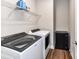 Modern laundry room equipped with a washer, dryer, and wire shelving for storage at 3012 Ocean Dr, Monroe, NC 28110