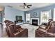 Cozy living room with a fireplace, plush leather seating, and abundant natural light at 3012 Ocean Dr, Monroe, NC 28110