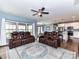 Open-concept living area flows into the kitchen, featuring leather couches and large windows at 3012 Ocean Dr, Monroe, NC 28110