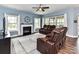 Inviting living room featuring a fireplace, large windows, and comfortable leather furniture at 3012 Ocean Dr, Monroe, NC 28110