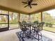 Screened-in porch featuring an outdoor dining area with a table, chairs, and a ceiling fan at 3012 Ocean Dr, Monroe, NC 28110