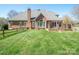 Brick home with a well-manicured lawn, wood perimeter fence, and a large backyard at 3071 Ancestry Cir, Matthews, NC 28104