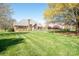 Large, landscaped backyard featuring a brick home with a wood perimeter fence at 3071 Ancestry Cir, Matthews, NC 28104