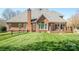 Spacious backyard featuring a brick home, well-manicured lawn, and wood perimeter fence at 3071 Ancestry Cir, Matthews, NC 28104