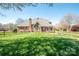 Manicured backyard featuring a brick home with a wood perimeter fence at 3071 Ancestry Cir, Matthews, NC 28104