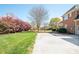 Spacious backyard with mature trees, with a brick house in the background, offering a serene outdoor space at 3071 Ancestry Cir, Matthews, NC 28104