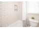 Water closet featuring a tub/shower combo with a white subway tile surround and a storage niche at 3071 Ancestry Cir, Matthews, NC 28104
