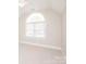 Neutral bedroom featuring a large window for natural light and neutral walls at 3071 Ancestry Cir, Matthews, NC 28104