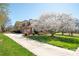 Long driveway leads to a brick home with a two-car garage and mature landscaping, offering curb appeal at 3071 Ancestry Cir, Matthews, NC 28104