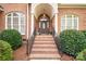 Elegant front entrance with brick steps and a decorative front door, enhancing curb appeal at 3071 Ancestry Cir, Matthews, NC 28104